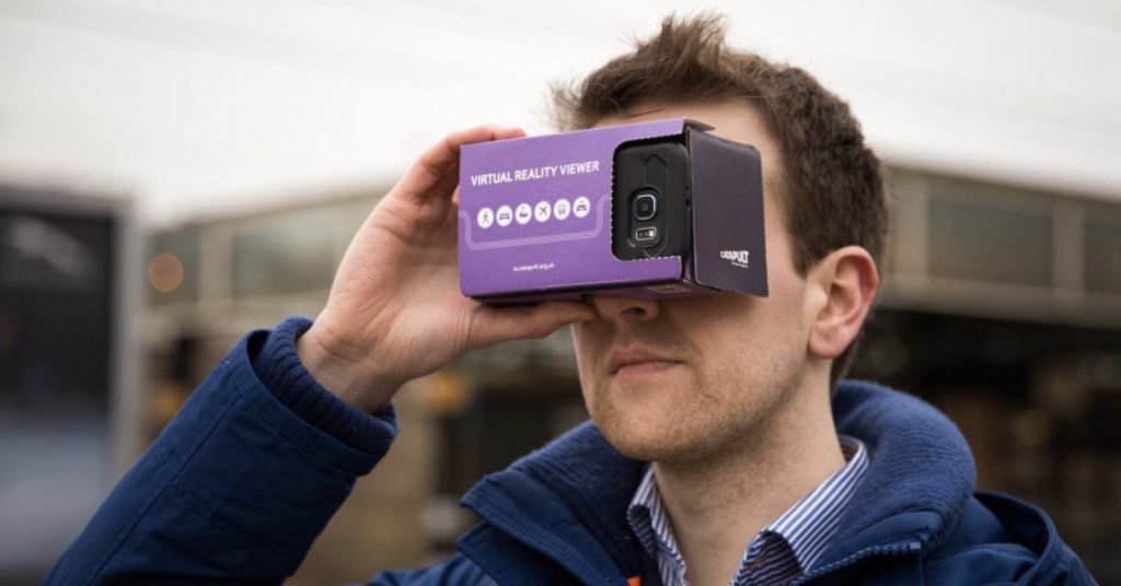 VR goggle system being held on face of user