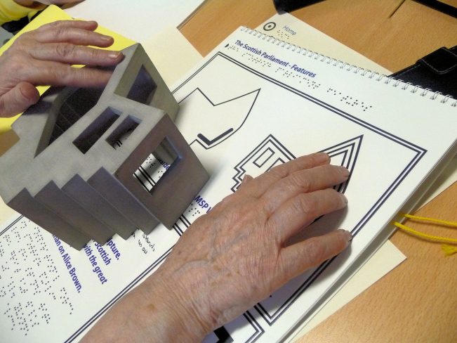 Tactile map and object being read by a blind person