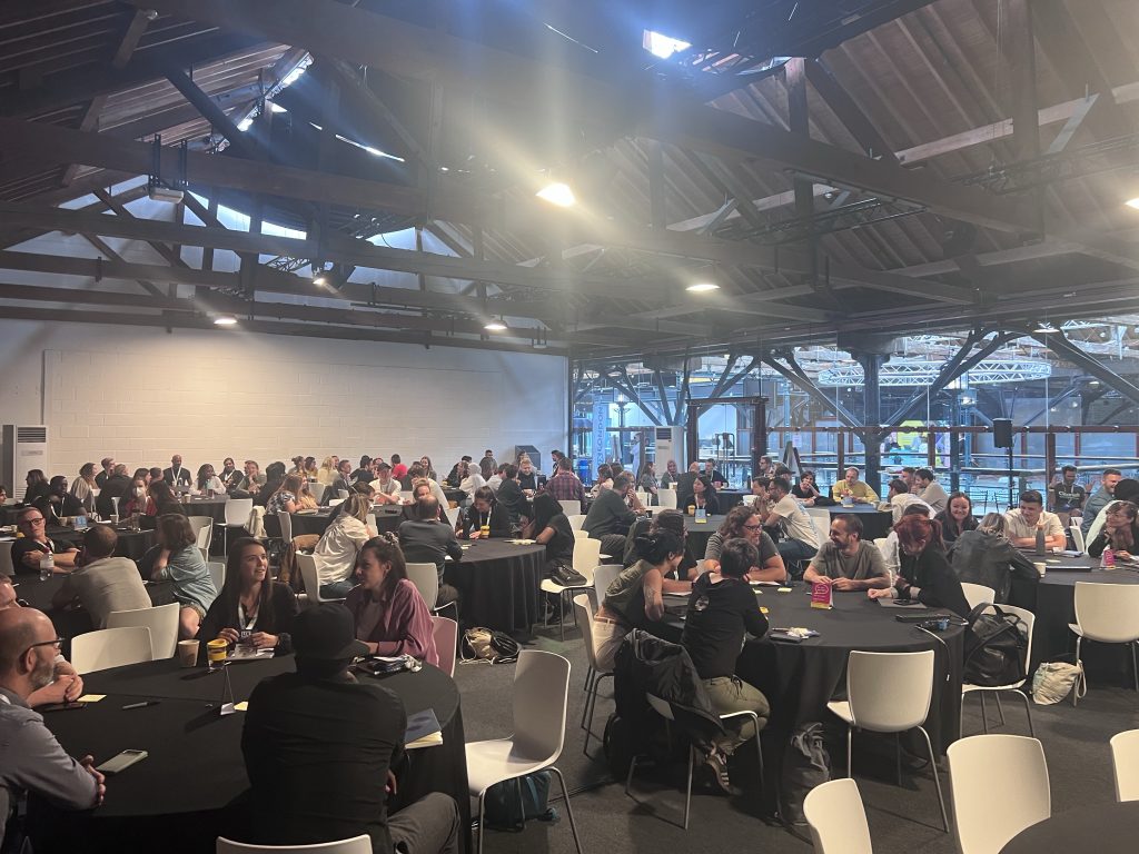 View across large workshop room with about 100 participants