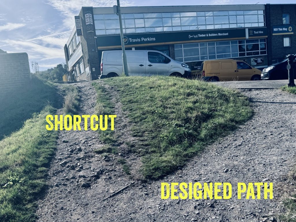 Next to the canal in Stroud, the designed path curves in graded slope to right up to pavement, the other path goes straight up and is roughly treaded and scrappy as it’s made for people’s feet