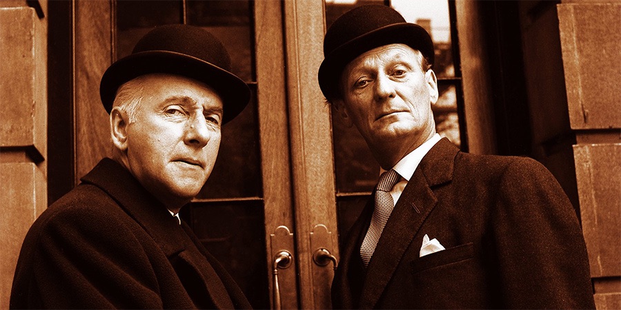 Two older white men in bowler hats looking superior and condescending