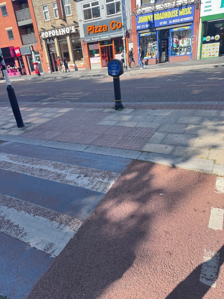 The Look Out for Cycles sign is covered with stickers obscuring the visual text